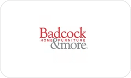 A white and red logo for badcock home furniture.