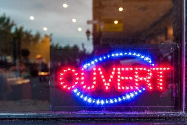 A neon sign that says ouvert in the window.