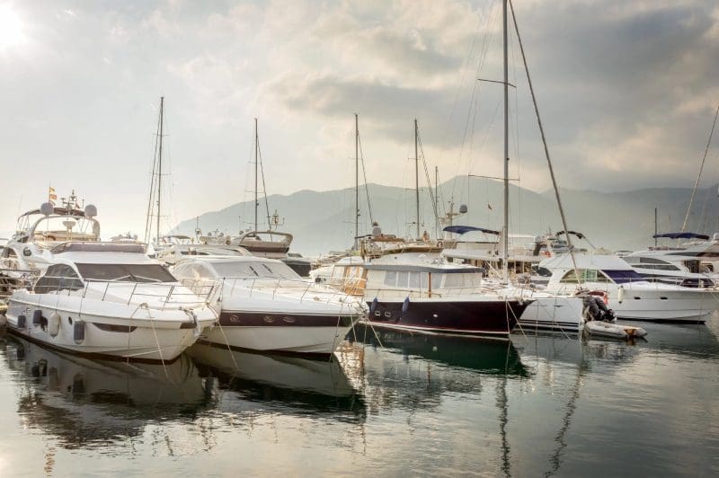 A group of boats in the water at sea.