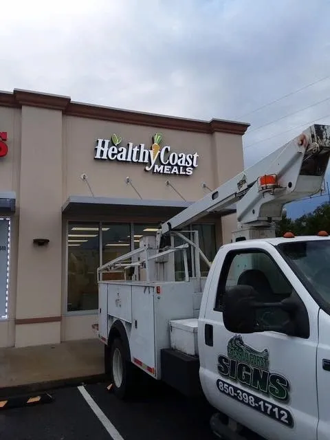 A white truck parked in front of a building.