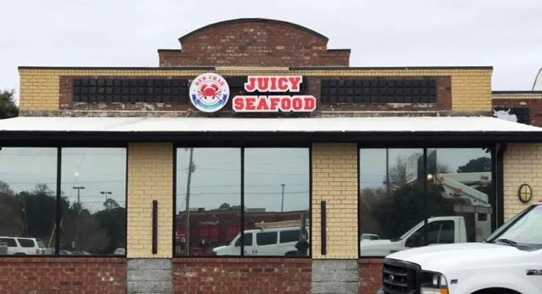 A restaurant with a large sign on the front of it.