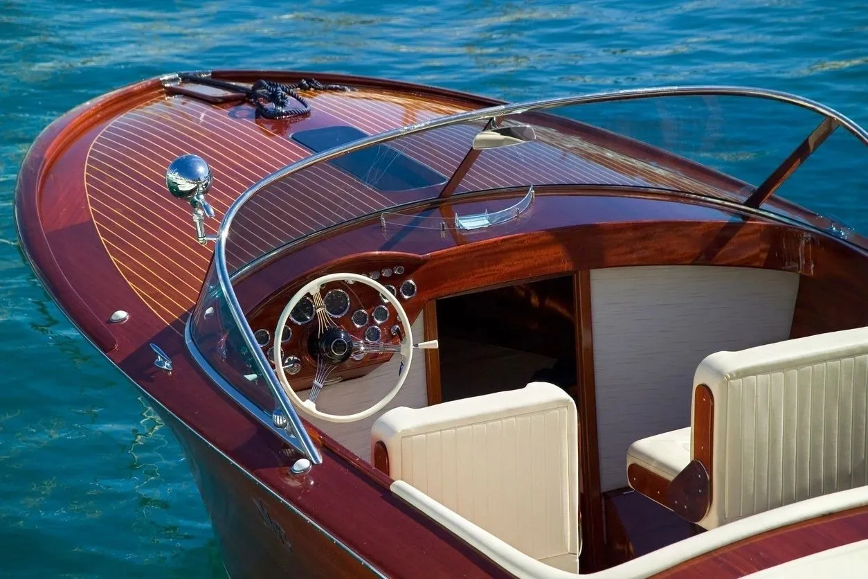 A boat with the steering wheel and dashboard in it.