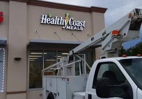 A white truck parked in front of a building.