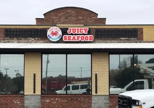 A restaurant with a large sign on the front of it.